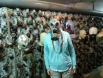 Wendy demonstrating a gas mask in the Nuclear Bunker