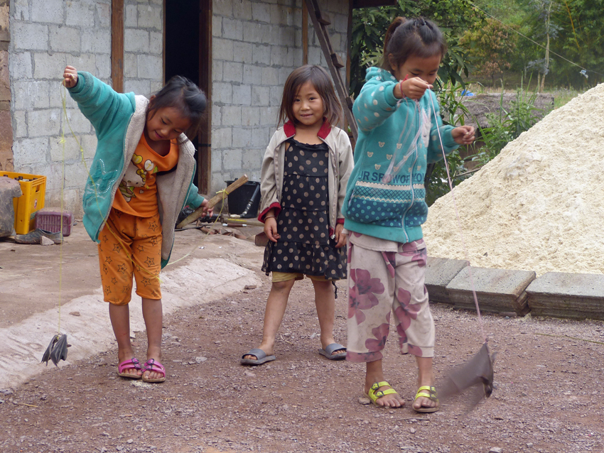Laos - children playing with bats