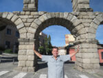 Greg Powers holding up the Acueduct in Segovia Spain